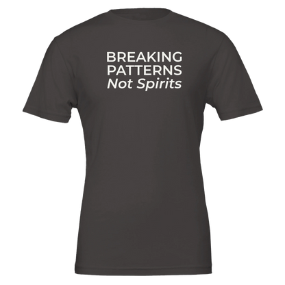 Flat lay of the “Breaking Patterns Not Spirits” t-shirt in Vintage Black, front view.
