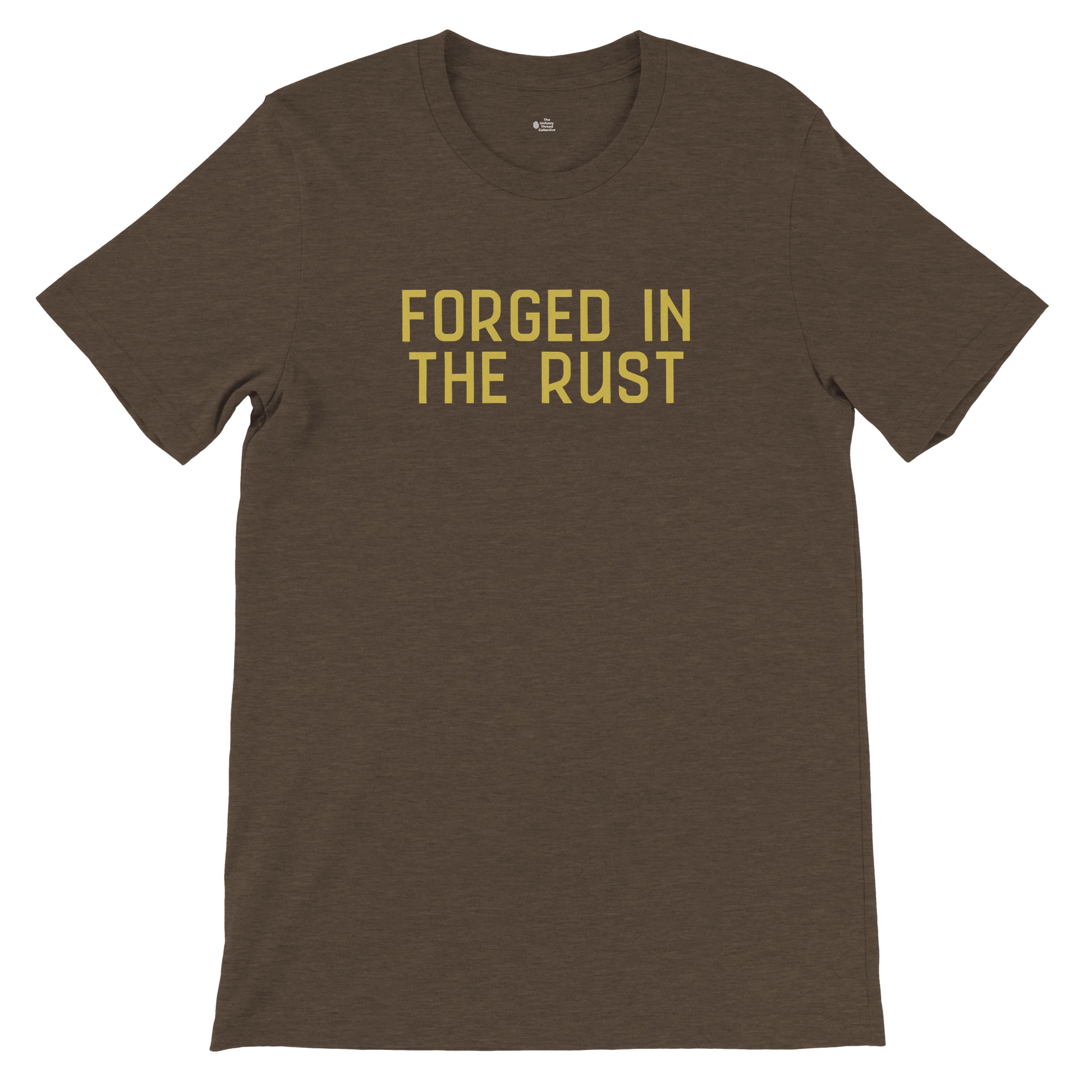 Bella+Canvas 3001 unisex tee in dark heather brown featuring the text “FORGED IN THE RUST” in vintage yellow, flat lay front view.