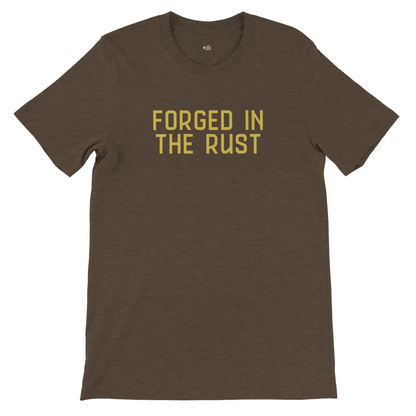 Bella+Canvas 3001 unisex tee in dark heather brown featuring the text “FORGED IN THE RUST” in vintage yellow, flat lay front view.