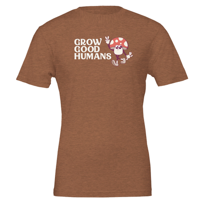 Flat lay of the “Grow Good Humans” t-shirt in Heather Autumn with peace-sign mushroom graphic, front view.