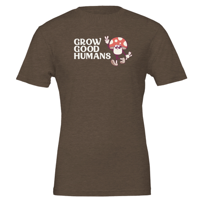 Flat lay of the “Grow Good Humans” t-shirt in Heather Brown with peace-sign mushroom graphic, front view.