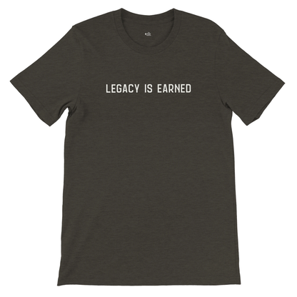 lat lay of “Legacy Is Earned” t-shirt in heather black with white text on the front.