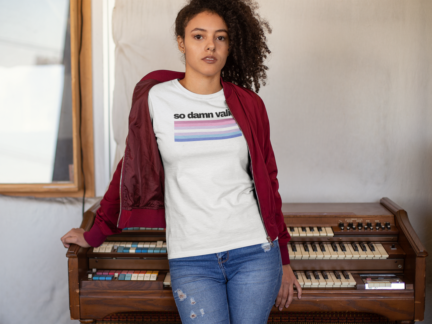 Unisex white t-shirt with the phrase "so damn valid." in black text above horizontal bigender pride stripes in pink, lavender, white, light blue, and royal blue.
