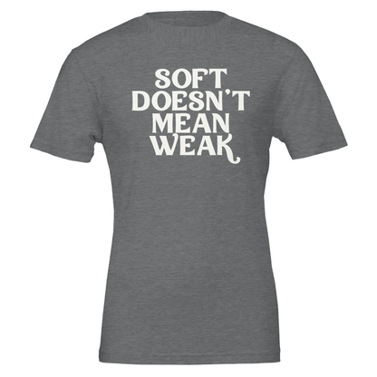  Flat lay of heather slate t-shirt displaying the phrase “Soft Doesn’t Mean Weak” in white block text.