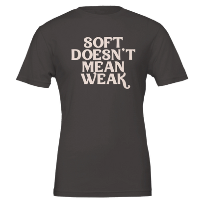 Flat lay of vintage black t-shirt with soft pink text reading “Soft Doesn’t Mean Weak.”