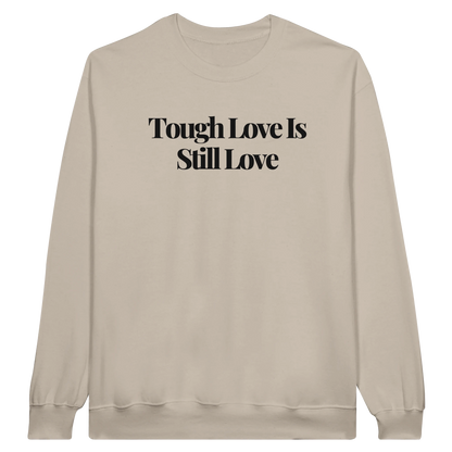 Tough Love Is Still Love midweight fleece crewneck sweatshirt in sand with bold text design on front.
