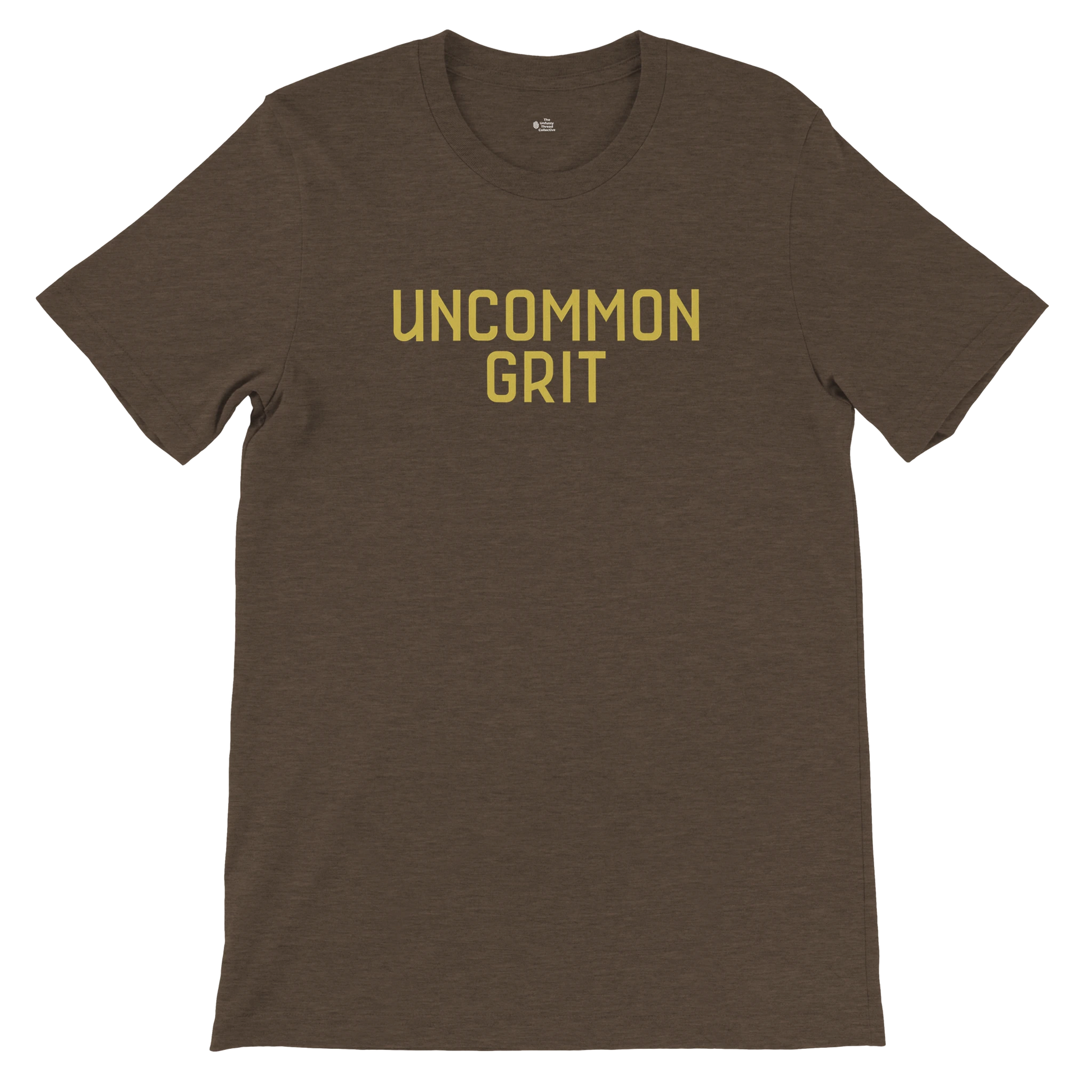 Flat lay of the Uncommon Grit Legacy Edition tee in Heather Brown with bold gold text on the chest.